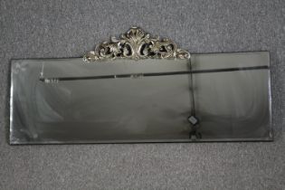 Wall mirror, contemporary bevelled glass with Rococo style cresting. H.54 W.120cm.