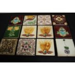 A mixed collection of twelve tiles. Including Art Nouveau and Majolica designs. H.15.5 W.15.5cm.