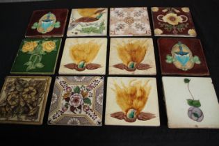 A mixed collection of twelve tiles. Including Art Nouveau and Majolica designs. H.15.5 W.15.5cm.