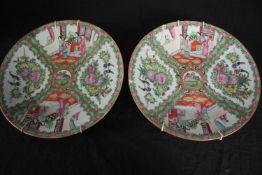 Two hand painted Chinese green famille plates. With a makers seal on the base (faint) and evidence