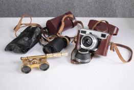 A Werra Camera, monocular and opera glasses. A cased collection. H.14 W.10cm. (largest)