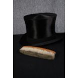 A boxed silk top hat and brush. The hat made by Karol Goeppert but with no marked size. H.20 W.34cm.