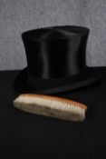 A boxed silk top hat and brush. The hat made by Karol Goeppert but with no marked size. H.20 W.34cm.