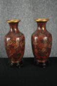 A matching pair of Chinese cloisonné vases on carved hardwood stands. Hand painted enamel on