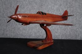 A large carved Supermarine Spitfire. Desk model. Missing one blade to its propeller and one