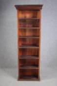 A full height stained hardwood open bookcase. H.193 W.67 D.26cm.