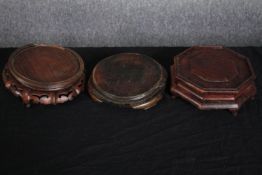 Three Chinese carved and pierced hardwood display stands. One of octagonal from. Dia.23cm. (largest)