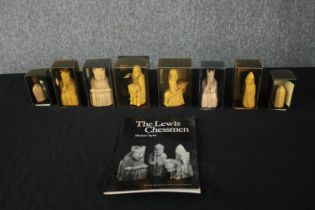 Chess. A collection of Lewis chessmen. Including the King and Queen, Knights, pawns and a rook.