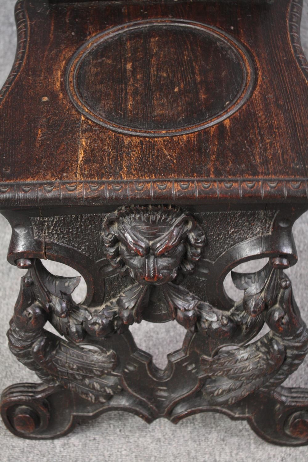 A pair of 19th century Italian carved oak Sgabello chairs. H.121cm. (Some carving missing as seen). - Image 4 of 9