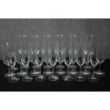 A collection of twenty-two Champagne glasses, one set by Dartington. H.23cm. (largest)