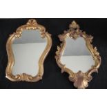 A carved giltwood Rococo style wall mirror along wth a similar mirror. H.50 W.28cm. (largest)