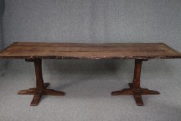 A Stewart Linford antique style oak refectory table with planked top and cleated ends on chamfered