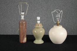 Three ceramic lamps. Including an old bottle stamped 'Amsterdam' that has been converted into a
