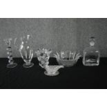 A mixed collection of glass including a decanter, candlestick and bowls one of which is in the shape