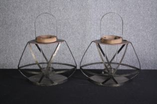 Two metal candleholders. H.49cm.(each).