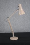 A vintage anglepoise lamp in a cream finish.