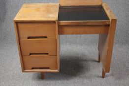 A mid century light teak dressing table by John and Sylvia Reid for Stag Furniture fitted with