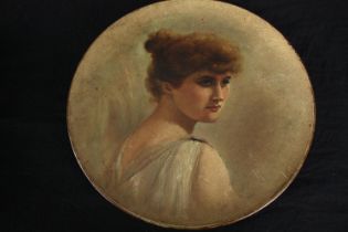 A painted wall plate with a portrait of a young women. Unsigned. Dia.29cm.