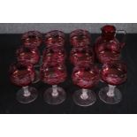 Eleven Victorian Cranberry glasses and jug. H.15cm. (each)