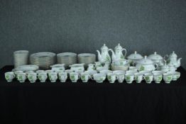 A large Konigl Pr Tettau tea set made up of two teapots, a coffee pot, sugar bowls, creamers, side