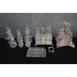 A collection of glass and silver plate cruet sets, butter dish, and bowl. The cruet sets are