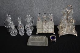 A collection of glass and silver plate cruet sets, butter dish, and bowl. The cruet sets are
