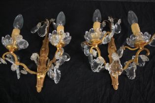 A pair of early 20th century cut crystal twin branch gilt metal wall sconces. H.32cm (each)