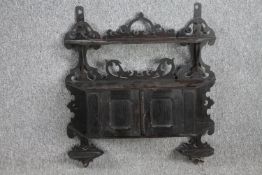 A 19th century ebonised hanging cabinet. H.65 W.62 D.17cm.