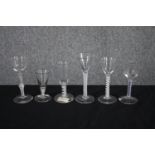 A mixed collection of six 18th and 19th century air twist stem wine glasses. One with a royal blue