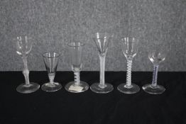 A mixed collection of six 18th and 19th century air twist stem wine glasses. One with a royal blue