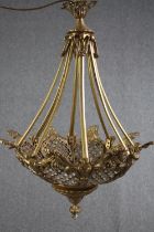 A foliate design chandelier of four lights. Glass in a brass mesh. Probably mid twentieth century.