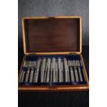 A complete Victorian mahogany canteen of silver plate cutlery for twelve people. The handles with