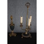 Two brass lamps. One in the shape of a three branch candleholder. The other brass with a green glass