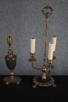 Two brass lamps. One in the shape of a three branch candleholder. The other brass with a green glass