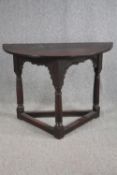 Hall table, 17th century carved oak with demi lune top on stretchered turned supports. H.78 W.107