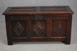 Coffer, 18th century carved panelled oak on stile supports. H.58 W.98 D.43cm.