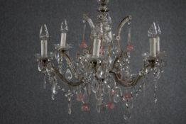 A Murano glass chandelier with six brass branches. Decorated with crystal swags, pale pink glass