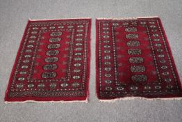 Two small Bokhara style rugs. L.92 W.67cm. (each)