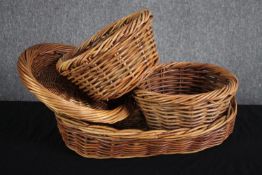 A collection of four wicker baskets. L.50cm.(largest)