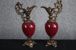 A matching pair of brass and porcelain ewers. Garniture in the style of Louis XV. H.30cm. (each)