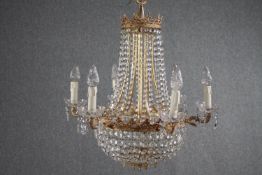 A French brass basket chandelier decorated with hanging crystal swags and beads of glass. H.75 Dia.