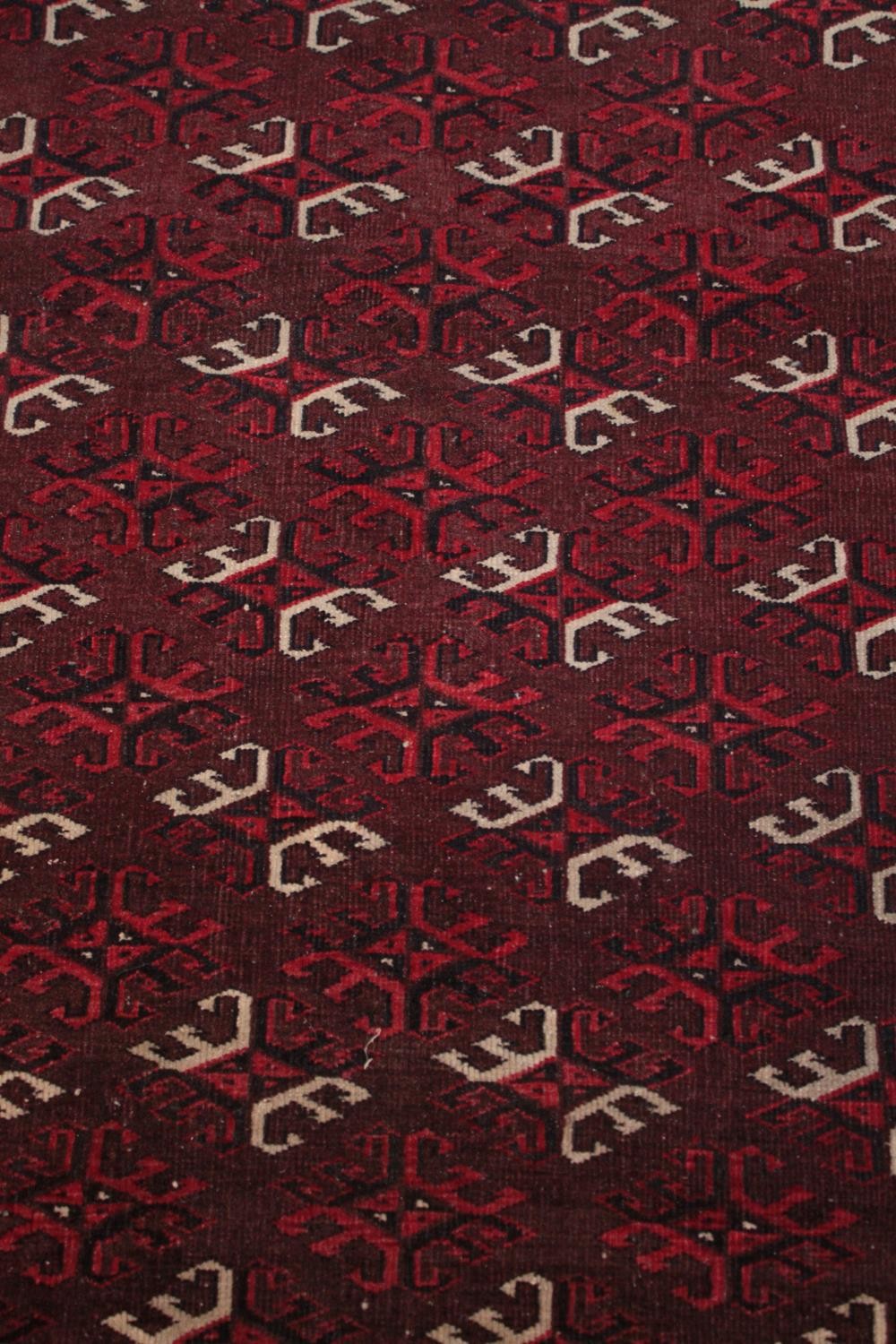 Rug, Belouch with repeating stylised motifs on a burgundy ground within multiple borders. L.167 W. - Image 2 of 4