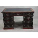 Pedestal desk, late 19th century carved oak with Green Man mask handles and tooled leather inset