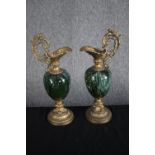 A matching pair of decorative brass and green porcelainewers. Garniture in the style of Louis XV.