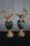 A matching pair of decorative brass and green porcelainewers. Garniture in the style of Louis XV.