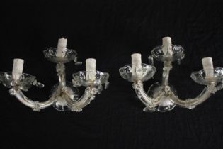 A pair of crystal glass three branch wall sconces with floral detailing. H.21cm. (each)