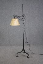 A wrought iron floor standing lamp. H.155cm.