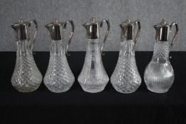 A set of five Claret decanters with silver plated handles and lips. H.29cm. (each)