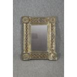 A metal framed mirror set with small glazed tiles. H.67 W.52cm.