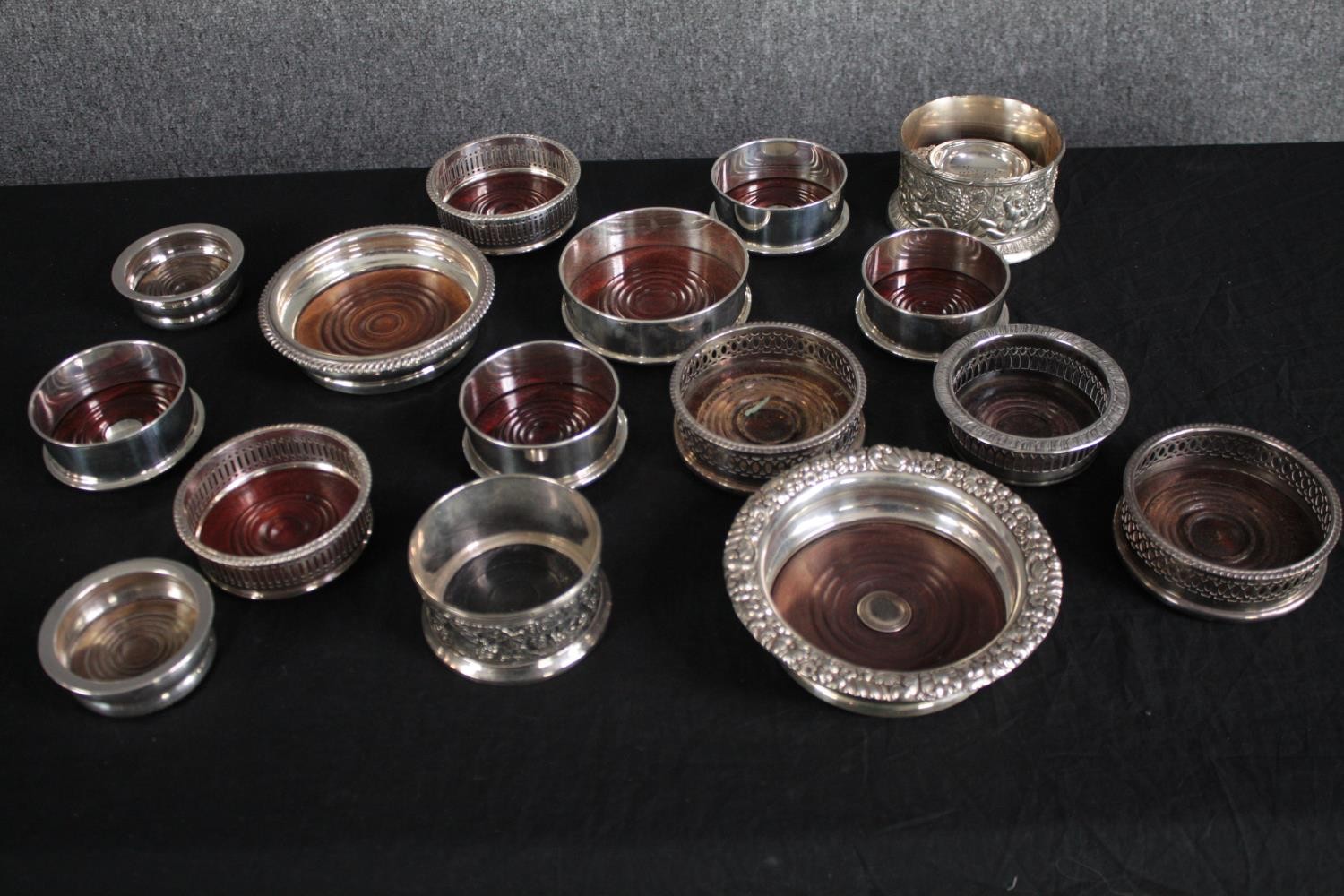 An assortment of silver plate wine stands and a tea strainer. Dia.17cm. (largest)